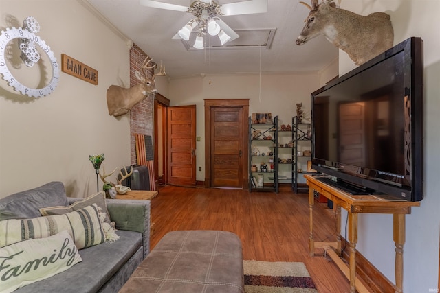 650 Main St, Rockport, IN 47635 - living area with attic access, ceiling fan, wood finished floors, and crown molding