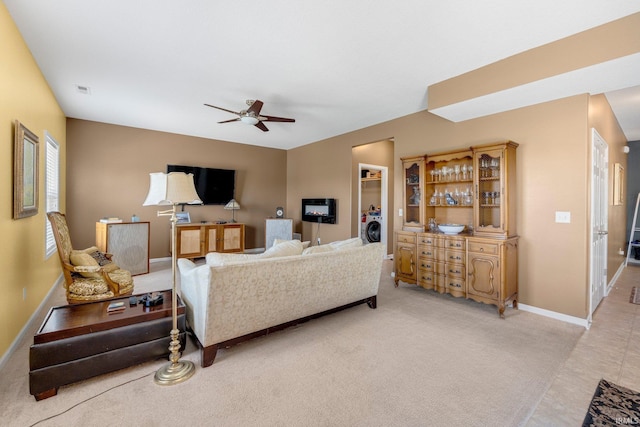 1823 Apopka Way, Fort Wayne, IN 46814 - living room featuring a ceiling fan, light colored carpet, and washer / clothes dryer