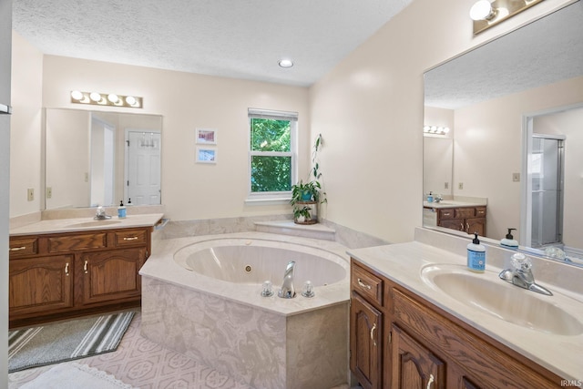 210 N Brookfield Dr, Lafayette, IN 47905 - bathroom with a stall shower, two vanities, a jetted tub, a textured ceiling, and tile patterned floors