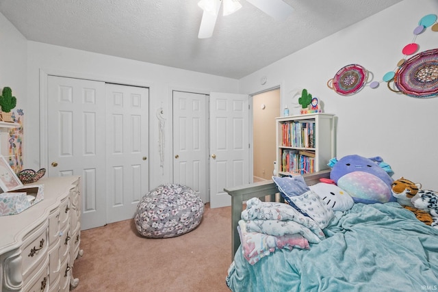 210 N Brookfield Dr, Lafayette, IN 47905 - bedroom featuring light carpet, a textured ceiling, ceiling fan, and multiple closets