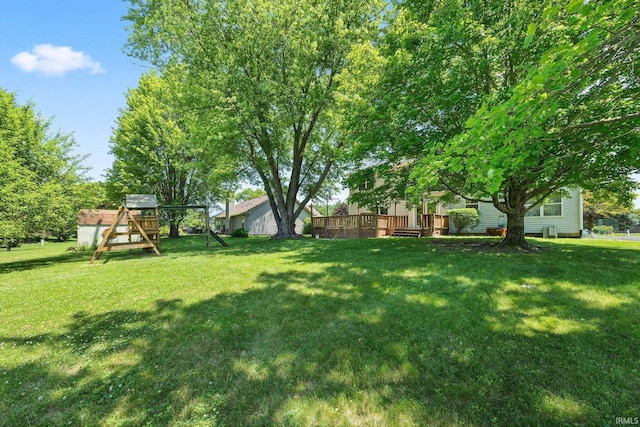 210 N Brookfield Dr, Lafayette, IN 47905 - view of green lawn with a playground and a deck
