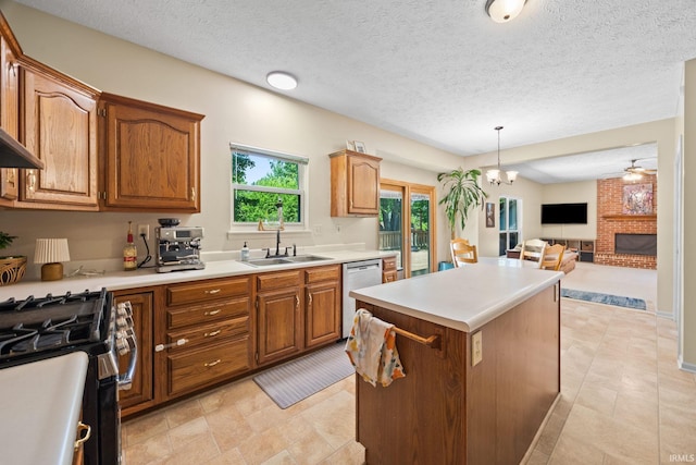 210 N Brookfield Dr, Lafayette, IN 47905 - kitchen featuring appliances with stainless steel finishes, a kitchen island, brown cabinetry, light countertops, and decorative light fixtures