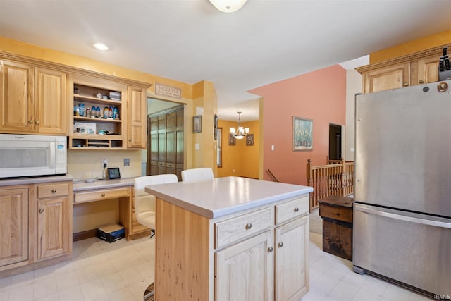 5171 N 350 E, Rolling Prairie, IN 46371 - kitchen with freestanding refrigerator, white microwave, a chandelier, built in study area, and open shelves