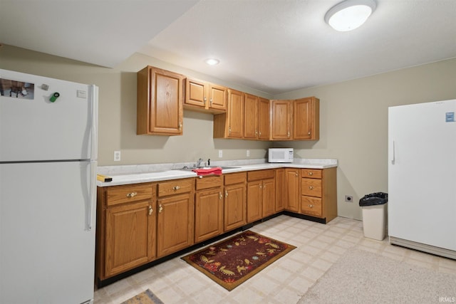 5171 N 350 E, Rolling Prairie, IN 46371 - kitchen featuring white appliances, light floors, light countertops, and brown cabinets