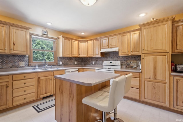 5171 N 350 E, Rolling Prairie, IN 46371 - kitchen featuring under cabinet range hood, white appliances, and light brown cabinets