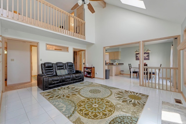 9502 Sail Wind Dr, Fort Wayne, IN 46804 - living room with light tile patterned flooring, high vaulted ceiling, a ceiling fan, and a skylight