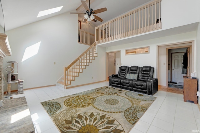 9502 Sail Wind Dr, Fort Wayne, IN 46804 - tiled living room with a skylight, stairway, high vaulted ceiling, and a ceiling fan