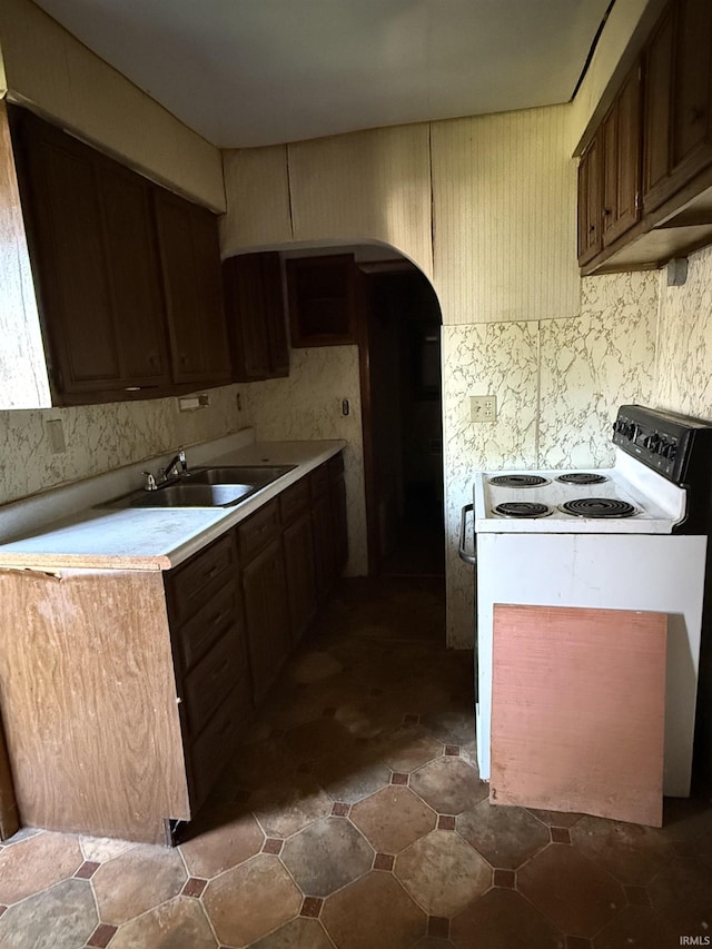 215 W 7th St, Marion, IN 46952 - kitchen featuring electric stove, arched walkways, and light countertops