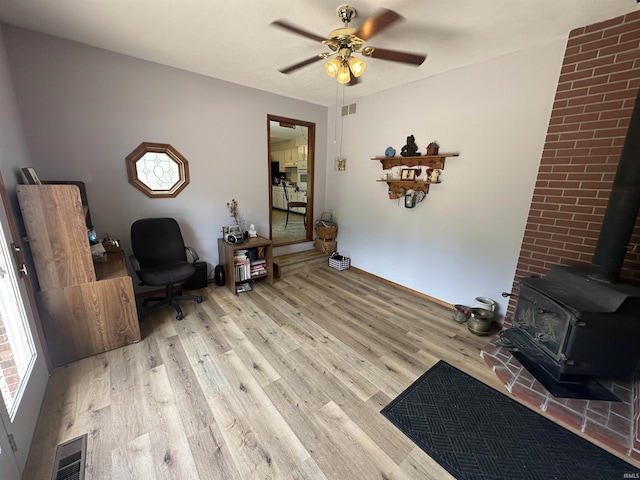 4813 N Old State Road 37, Springville, IN 47462 - sitting room with a wood stove, wood finished floors, and a ceiling fan