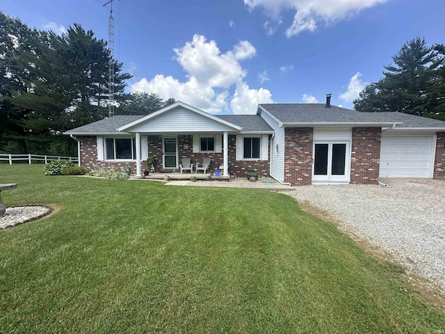 4813 N Old State Road 37, Springville, IN 47462 - view of front of home featuring covered porch, brick siding, an attached garage, and gravel driveway