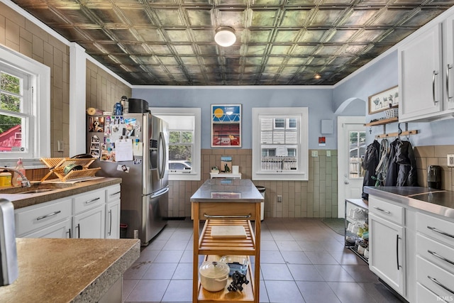 4721 Carrollton Ave, Indianapolis, IN 46205 - kitchen featuring tile walls, an ornate ceiling, open shelves, stainless steel refrigerator with ice dispenser, and tile patterned flooring