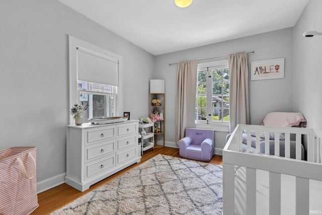 4721 Carrollton Ave, Indianapolis, IN 46205 - bedroom with wood finished floors and a nursery area