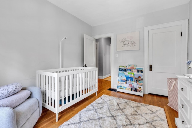 4721 Carrollton Ave, Indianapolis, IN 46205 - bedroom with wood finished floors and a nursery area