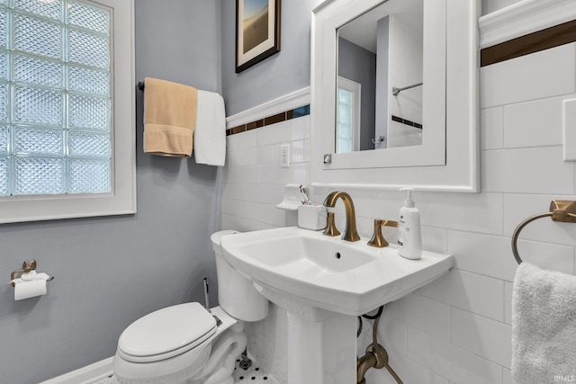 4721 Carrollton Ave, Indianapolis, IN 46205 - bathroom with plenty of natural light, tile walls, and backsplash
