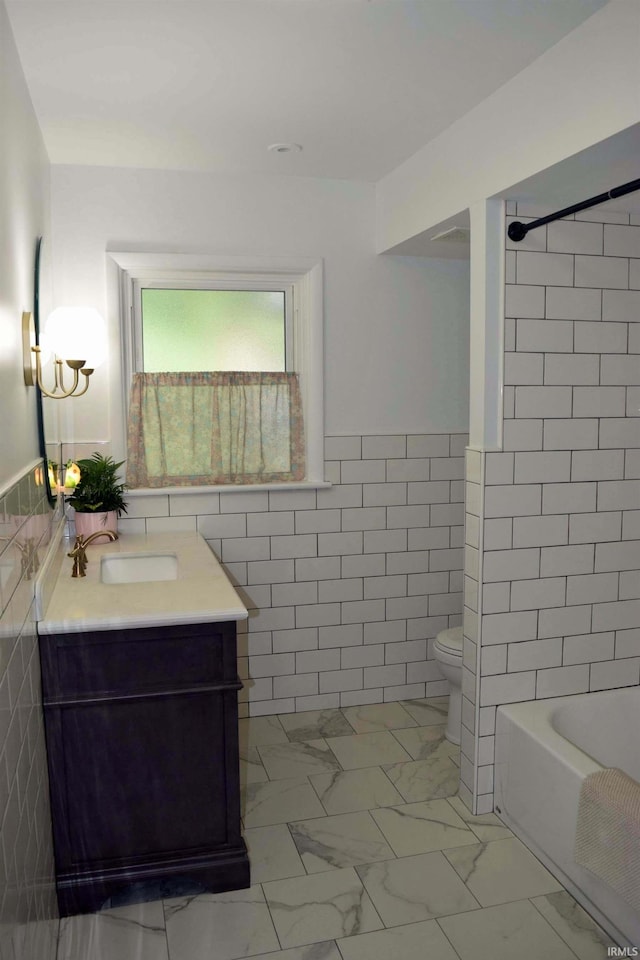 2020 N Red Bank Rd, Evansville, IN 47720 - bathroom with tile walls, vanity, shower / bath combination, marble finish flooring, and a wainscoted wall