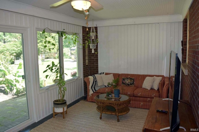 2020 N Red Bank Rd, Evansville, IN 47720 - living area featuring healthy amount of natural light, carpet flooring, brick wall, and a ceiling fan