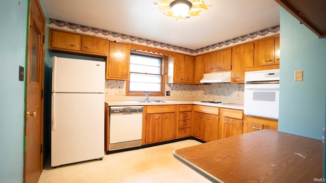 4409 Austin Dr, Fort Wayne, IN 46806 - kitchen with white appliances, under cabinet range hood, brown cabinets, and decorative backsplash