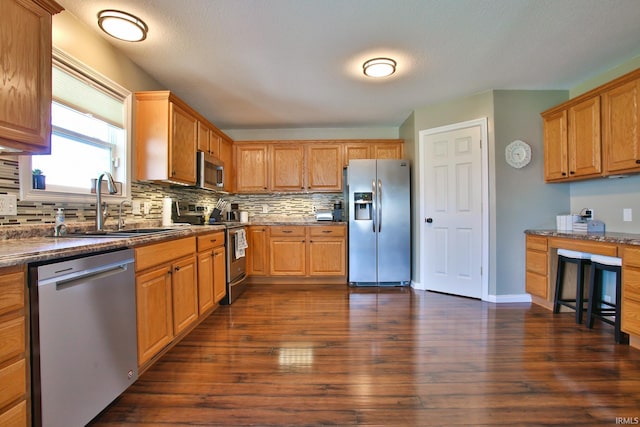 3517 Boulder Pass, Fort Wayne, IN 46818 - kitchen with appliances with stainless steel finishes, tasteful backsplash, and dark wood-style flooring