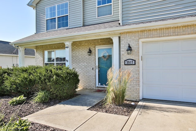 3517 Boulder Pass, Fort Wayne, IN 46818 - doorway to property featuring brick siding, a shingled roof, and an attached garage