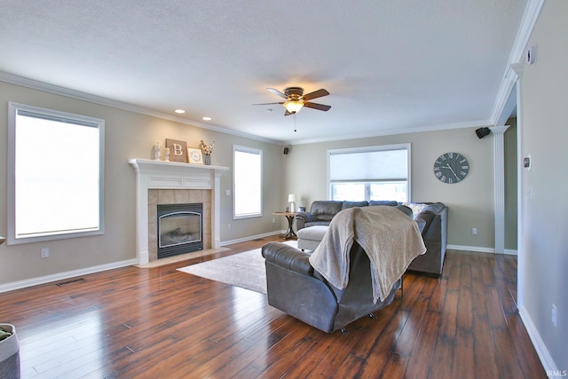 3517 Boulder Pass, Fort Wayne, IN 46818 - living area featuring a tile fireplace, a ceiling fan, dark wood-style flooring, crown molding, and recessed lighting