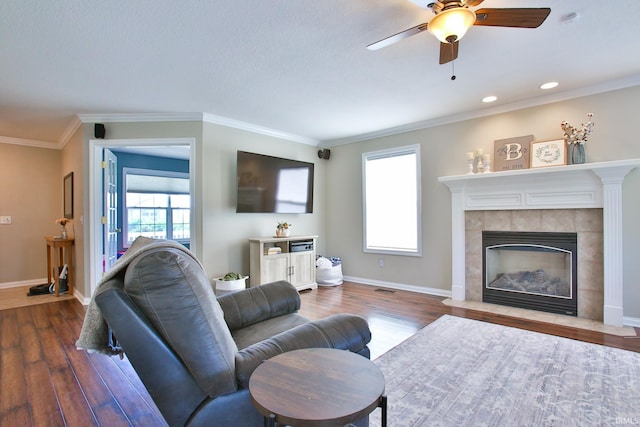 3517 Boulder Pass, Fort Wayne, IN 46818 - living area with wood finished floors, ceiling fan, a tiled fireplace, ornamental molding, and recessed lighting