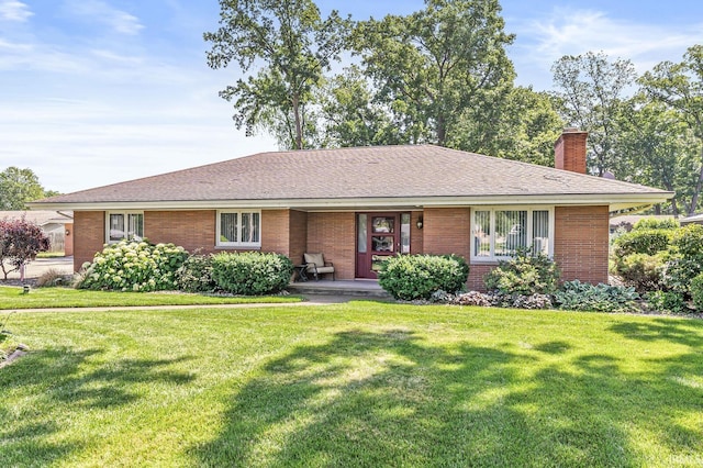 56928 County Road 13, Elkhart, IN 46516 - ranch-style home featuring a chimney, brick siding, a front yard, and covered porch