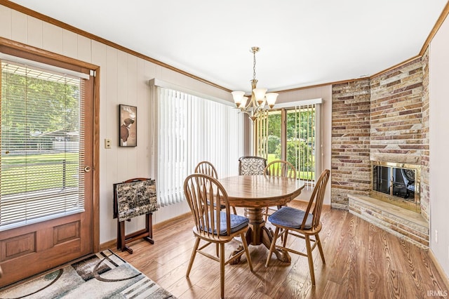 56928 County Road 13, Elkhart, IN 46516 - dining room featuring ornamental molding, a chandelier, light wood finished floors, and a large fireplace