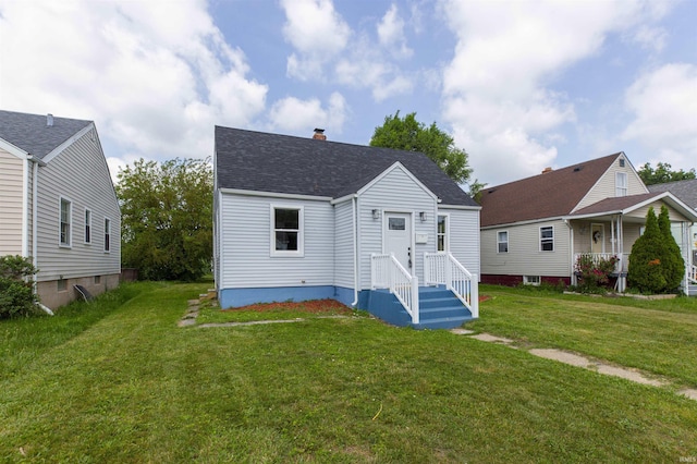 717 S Falcon St, South Bend, IN 46619 - back of house featuring a yard, a chimney, and a shingled roof