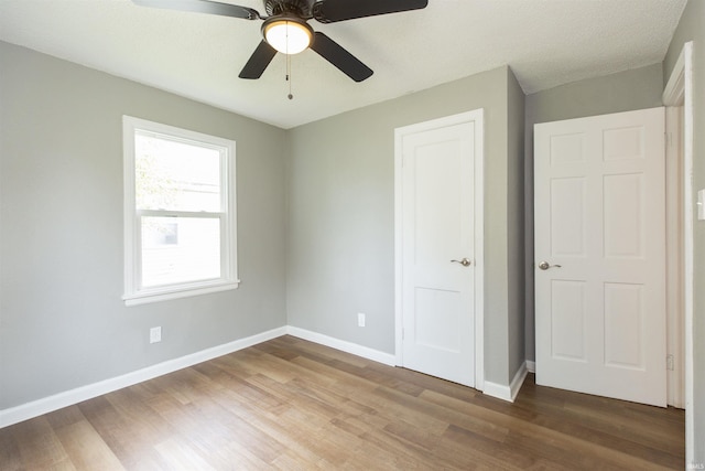 717 S Falcon St, South Bend, IN 46619 - unfurnished bedroom with wood finished floors and ceiling fan