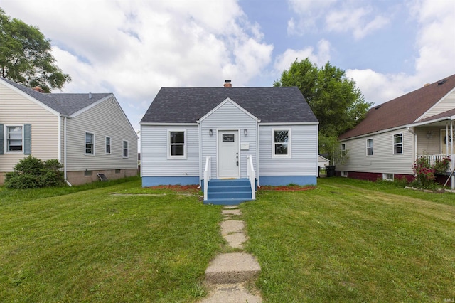 717 S Falcon St, South Bend, IN 46619 - view of front of house featuring a chimney, a front lawn, and a shingled roof