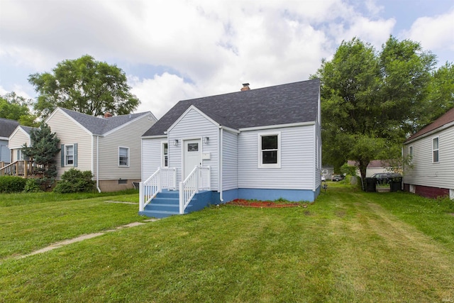 717 S Falcon St, South Bend, IN 46619 - view of front of property featuring a front yard, roof with shingles, and a chimney