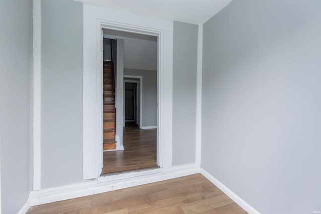 717 S Falcon St, South Bend, IN 46619 - spare room featuring wood finished floors and stairway