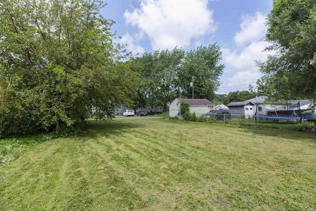 717 S Falcon St, South Bend, IN 46619 - view of green lawn with a trampoline
