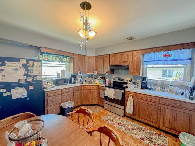 310 Corwin Ln, Fort Wayne, IN 46816 - kitchen featuring stainless steel electric range, freestanding refrigerator, under cabinet range hood, light countertops, and hanging light fixtures