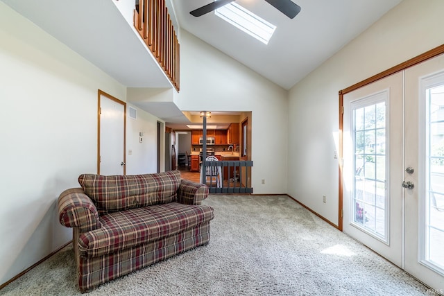 11215 Crested Oak Ct, Fort Wayne, IN 46845 - carpeted living area with vaulted ceiling, a skylight, french doors, and ceiling fan
