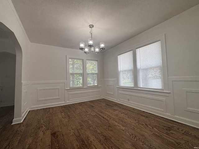 2521 N Red Bank Rd, Evansville, IN 47720 - unfurnished dining area with arched walkways, wainscoting, dark wood-type flooring, a chandelier, and a decorative wall