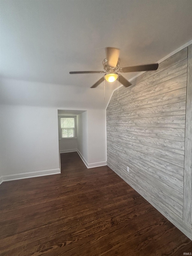2521 N Red Bank Rd, Evansville, IN 47720 - spare room with wooden walls, ceiling fan, dark wood-style floors, and lofted ceiling