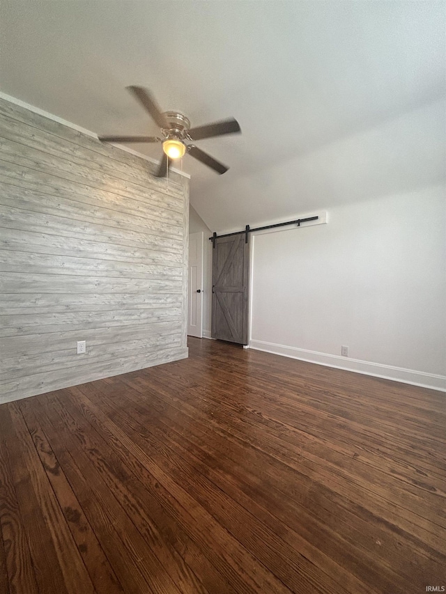 2521 N Red Bank Rd, Evansville, IN 47720 - unfurnished room with vaulted ceiling, a ceiling fan, a barn door, and dark wood-type flooring