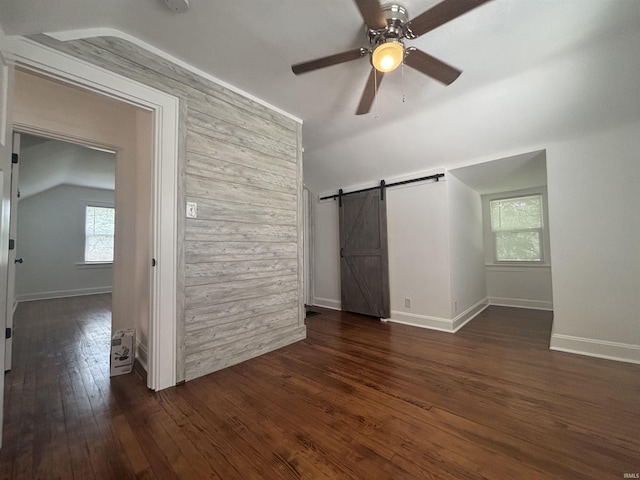 2521 N Red Bank Rd, Evansville, IN 47720 - unfurnished room featuring a barn door, lofted ceiling, plenty of natural light, hardwood / wood-style floors, and ceiling fan