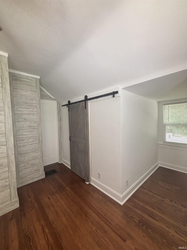 2521 N Red Bank Rd, Evansville, IN 47720 - bonus room with lofted ceiling, wood finished floors, a barn door, and a textured ceiling
