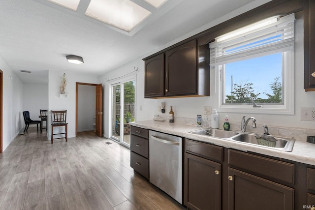 1936 Mark Anthony Xing, Fort Wayne, IN 46818 - kitchen featuring dishwasher, dark brown cabinetry, light countertops, and light wood finished floors
