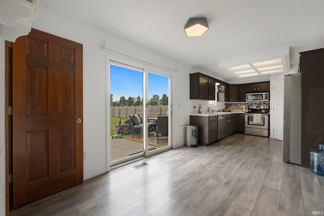 1936 Mark Anthony Xing, Fort Wayne, IN 46818 - kitchen with stainless steel appliances, light countertops, light wood-style floors, and dark brown cabinetry