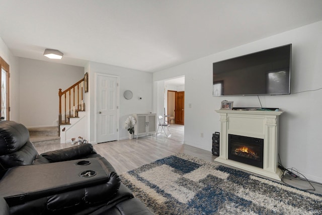 1936 Mark Anthony Xing, Fort Wayne, IN 46818 - living area featuring stairs, wood finished floors, and a glass covered fireplace