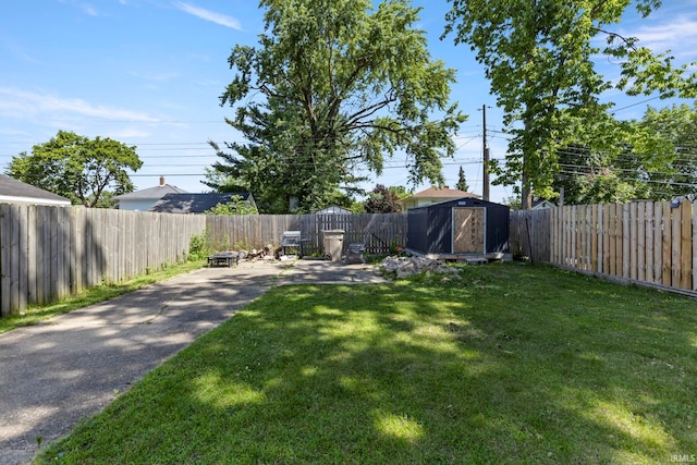 309 E Eckman St, South Bend, IN 46614 - fenced backyard with a storage unit and a patio area