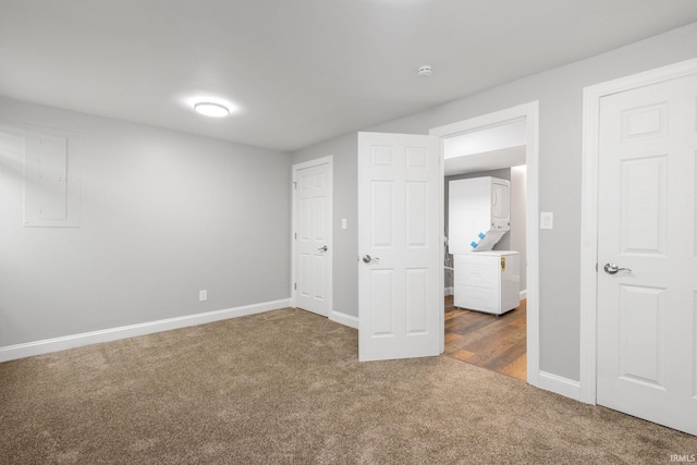 483 N Eddy St Lot # 32, South Bend, IN 46617 - unfurnished bedroom featuring stacked washer and clothes dryer and carpet