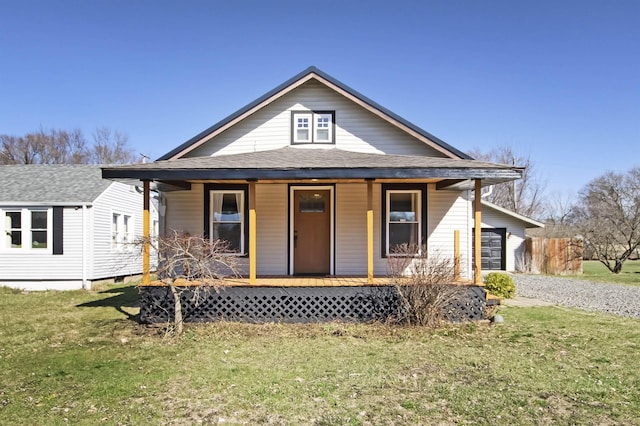 54054 N Ironwood Rd, South Bend, IN 46635 - view of front facade with covered porch, a front lawn, and roof with shingles