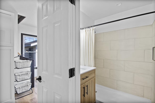 54054 N Ironwood Rd, South Bend, IN 46635 - bathroom with tiled shower, vanity, and wood finished floors