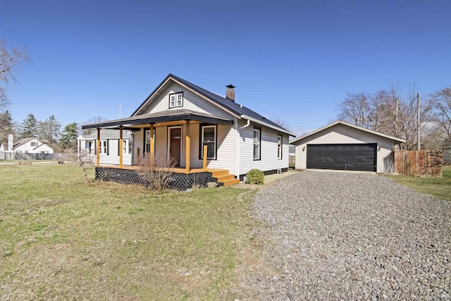 54054 N Ironwood Rd, South Bend, IN 46635 - view of front facade featuring a chimney, covered porch, a garage, and an outbuilding