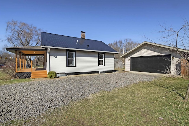 54054 N Ironwood Rd, South Bend, IN 46635 - rear view of house with a chimney, a metal roof, a yard, an outdoor structure, and a detached garage