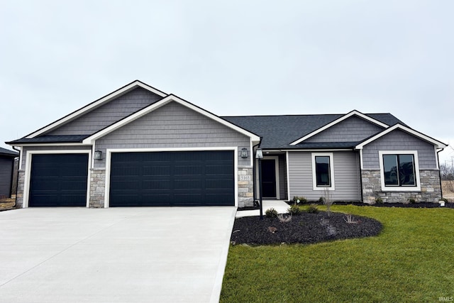 5165 Greyson Heights Dr, Auburn, IN 46706 - craftsman house with stone siding, a garage, concrete driveway, and a front yard